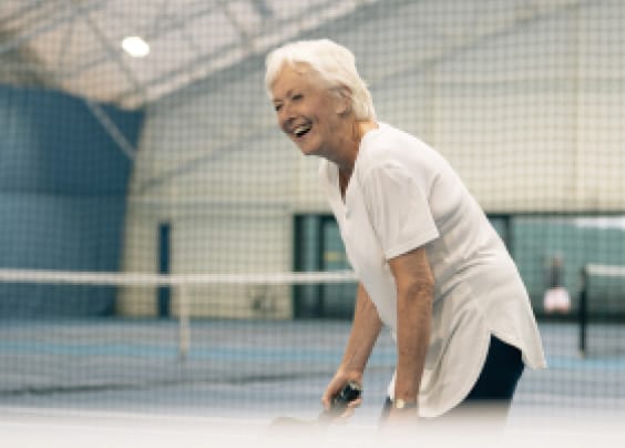 woman smiling playing tennis