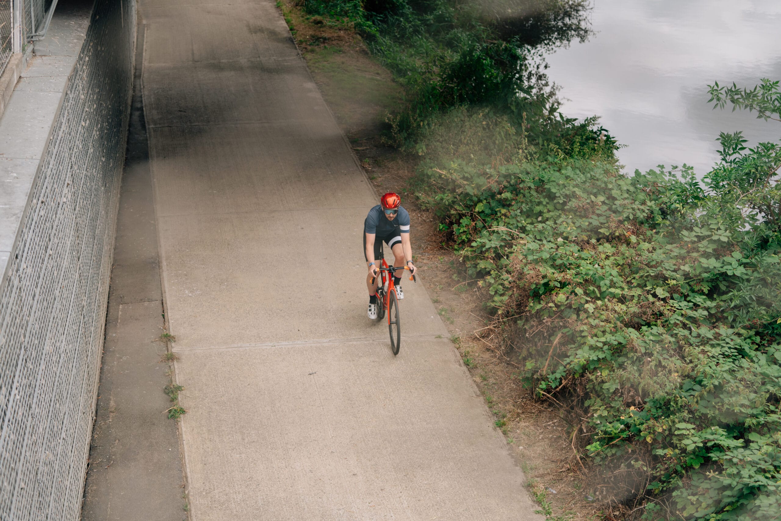man riding a bike outside on a path