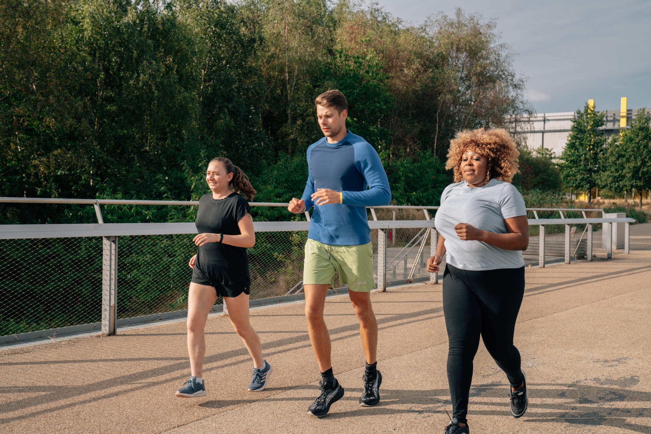 three people jogging outside