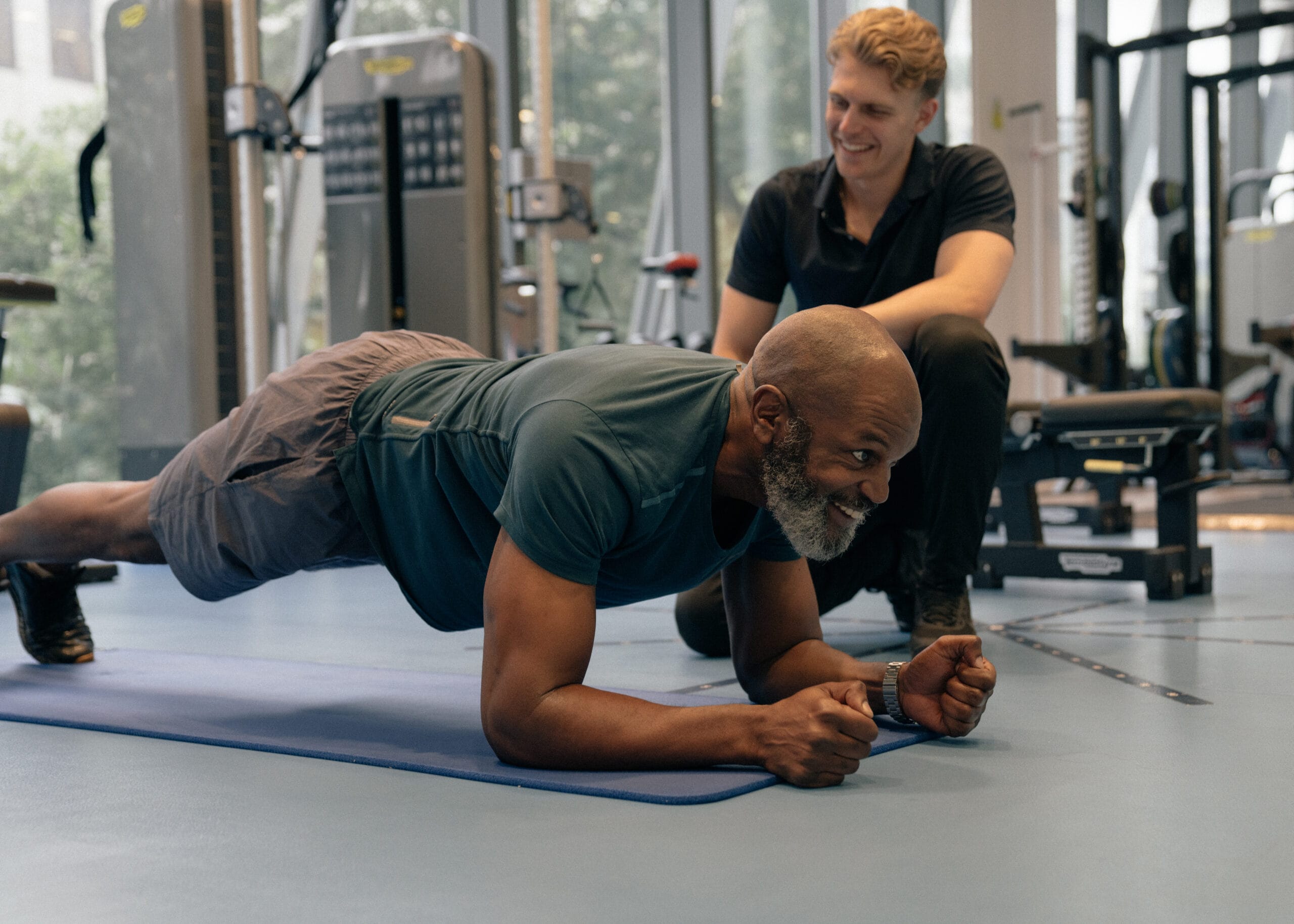 man holding a plank pose in gym