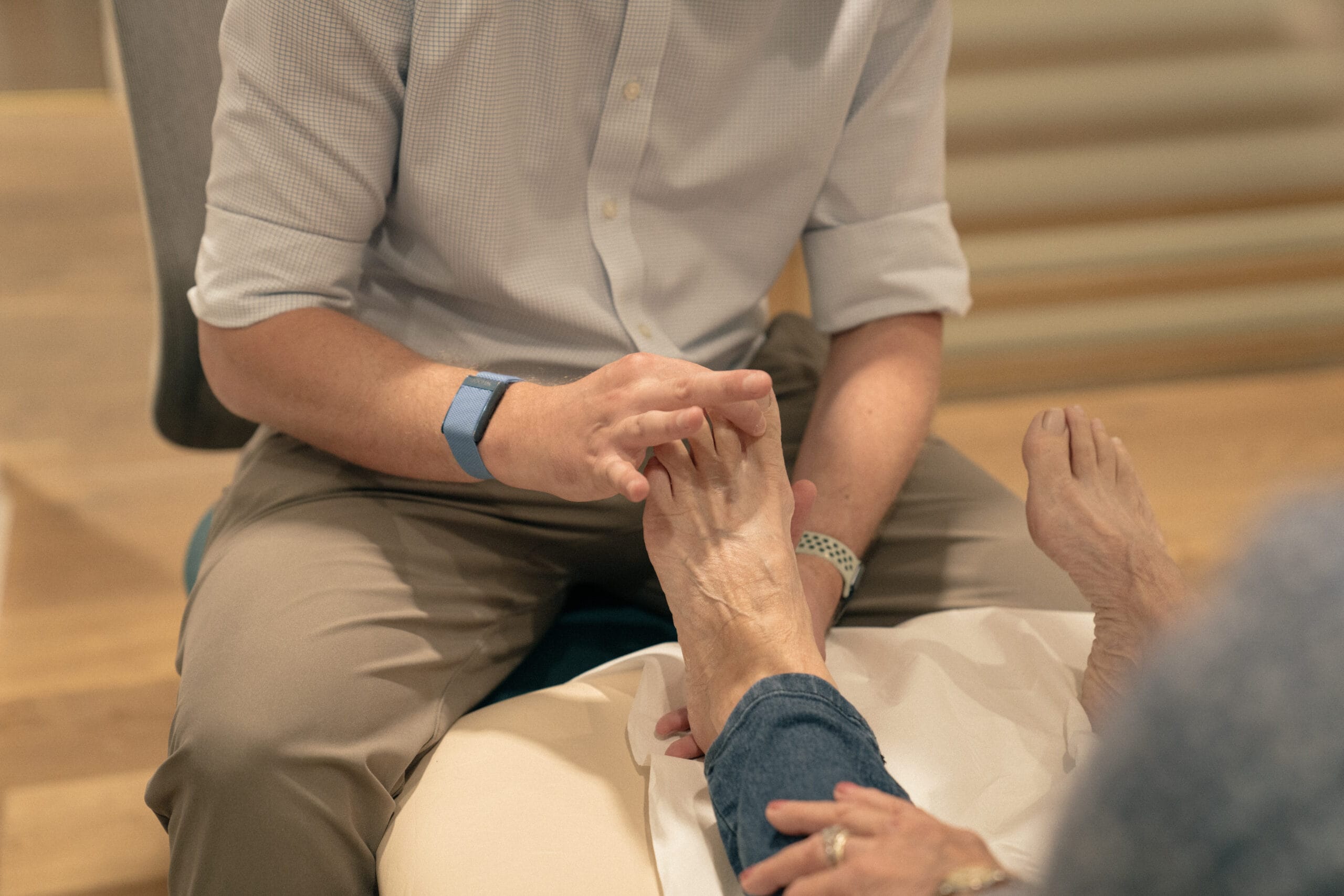 Clinician holding patient's toe in assessment