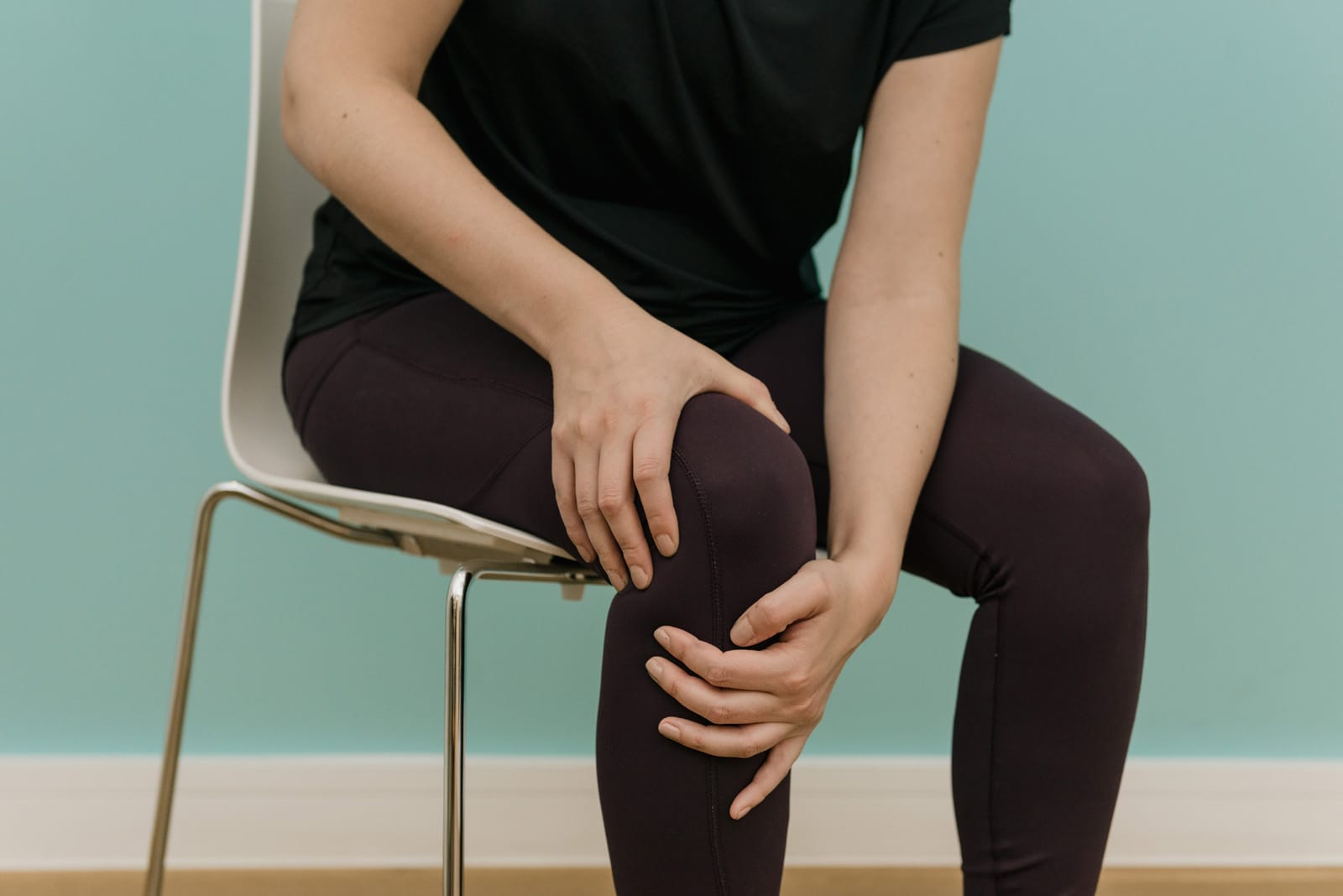 person holding knee sat down